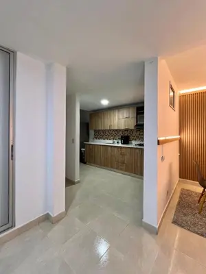 a large kitchen with wooden cabinets and a floor at Casa Eternal Comfort and Style in Envigado