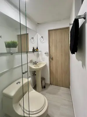 a bathroom with a toilet and a sink at Casa Eternal Comfort and Style in Envigado