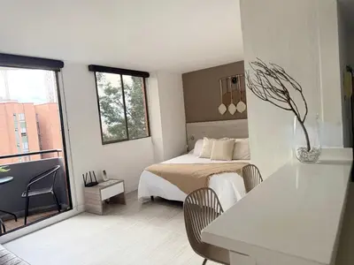 a white bedroom with a bed and a window at Ac, fast wifi 400 mg, quiet, nature in El Poblado in Medellín