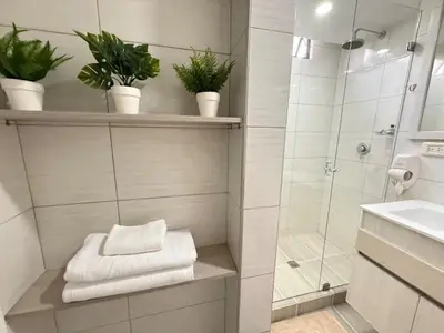 a bathroom with a shower and a sink with plants at Ac, fast wifi 400 mg, quiet, nature in El Poblado in Medellín