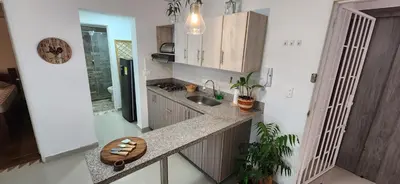a kitchen with a counter and a sink and a counter top at Casa Laureles 2do Parque in Medellín