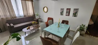 a living room with a couch and a table at Casa Laureles 2do Parque in Medellín
