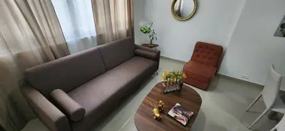 a living room with a couch and a table at Casa Laureles 2do Parque in Medellín