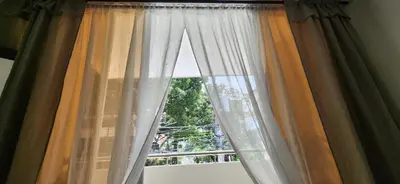a window with curtains in a room at Casa Laureles 2do Parque in Medellín