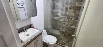 a bathroom with a toilet and a sink and a shower at Tu casa en Laureles in Medellín