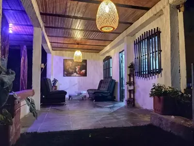 a living room with two chairs and a ceiling at Hostal otro cuento in Cisneros