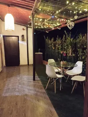 a dining room with a glass table and white chairs at Hostal otro cuento in Cisneros