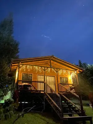 a house with a deck with lights on it at Cabaña de cuento in Horizonte