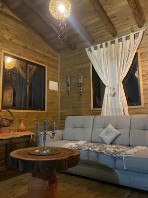 a living room with a blue couch and a table at Cabaña de cuento in Horizonte