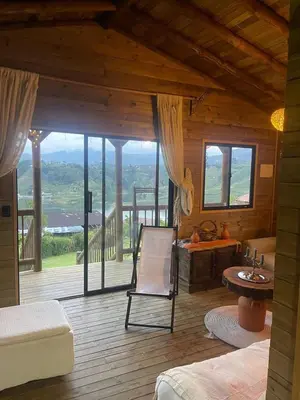 a room with a view of a room with a chair at Cabaña de cuento in Horizonte