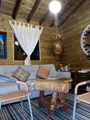 a living room with a couch and a table at Cabaña de cuento in Horizonte