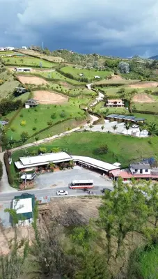 an aerial view of a school with buses in a parking lot at Suites del Lago in Marinilla