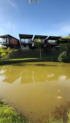 a house with a pond in front of it at Suites del Lago in Marinilla