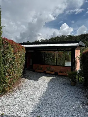 a building with a pavilion with plants in it at Suites del Lago in Marinilla