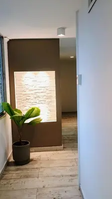 a potted plant in a room with a window at In the center of Poblado in Medellín