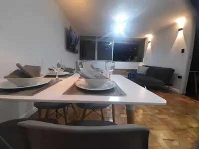a white table with plates and wine glasses on it at In the center of Poblado in Medellín