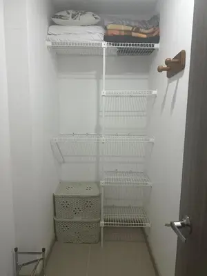 a white closet with white shelves and a towel at Beautiful Santa Fe de Antioquia DiSole apartment in Santa Fe de Antioquia
