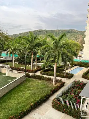 a resort with palm trees and a swimming pool at Beautiful Santa Fe de Antioquia DiSole apartment in Santa Fe de Antioquia