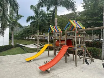 a playground with two slides and a play structure at Beautiful Santa Fe de Antioquia DiSole apartment in Santa Fe de Antioquia
