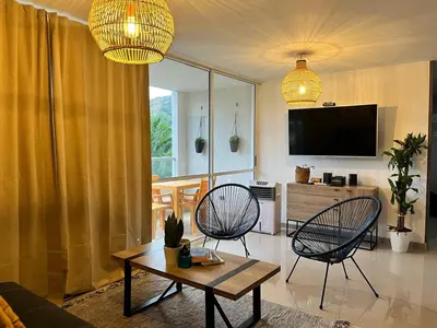 a living room with two chairs and a table at Beautiful Santa Fe de Antioquia DiSole apartment in Santa Fe de Antioquia
