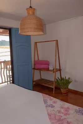 a bedroom with a bed and a table with a mirror at Hotel Casa Encanto Jardín in Jardin