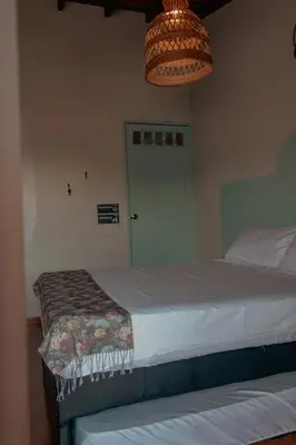 a bedroom with a bed and a green door at Hotel Casa Encanto Jardín in Jardin