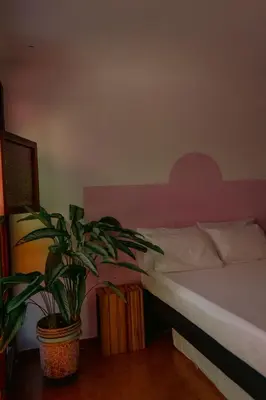 a bedroom with a bed and a potted plant at Hotel Casa Encanto Jardín in Jardin