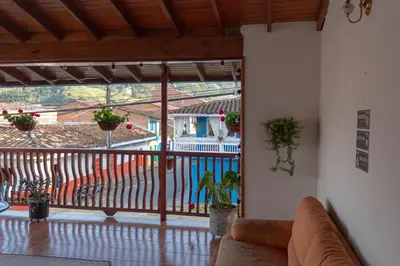 a living room with a couch and a balcony at Hotel Casa Encanto Jardín in Jardin