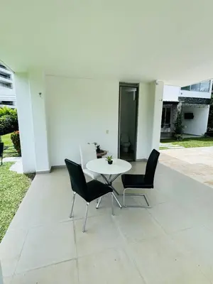 a white table and chairs on a patio at Finca de lujo con picsina en San Jerónimo Antioquia in San Jerónimo