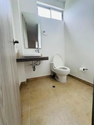 a bathroom with a toilet and a sink and a mirror at Finca de lujo con picsina en San Jerónimo Antioquia in San Jerónimo