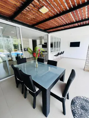 a dining room with a glass table and chairs at Finca de lujo con picsina en San Jerónimo Antioquia in San Jerónimo