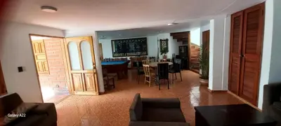 a living room and dining room with a table and chairs at Finca Villla las Palmas in Chiquinquirá