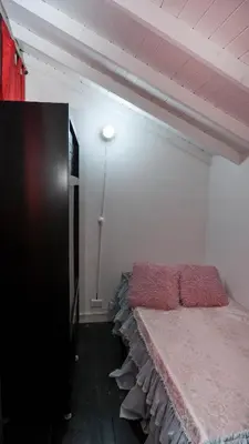 a bedroom with a bed with a pink blanket at Casa La Palma Habitación Altillo in Medellín