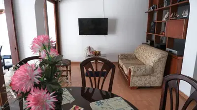 a living room with a table and chairs and a couch at Casa La Palma Habitación Altillo in Medellín