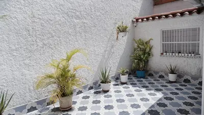 a courtyard with potted plants on a white building at Casa La Palma Habitación Altillo in Medellín
