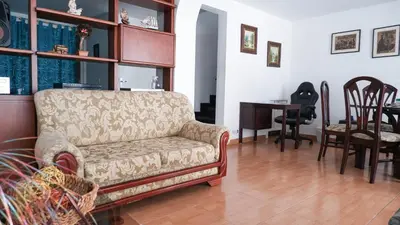 a living room with a couch and a table at Casa La Palma Habitación Altillo in Medellín