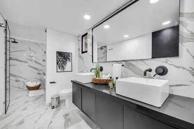 a white bathroom with a sink and a mirror at Moderno-Central El Poblado Apartamento in Medellín