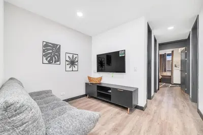 a living room with a couch and a flat screen tv at Moderno-Central El Poblado Apartamento in Medellín