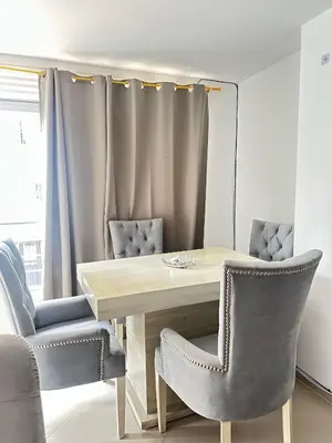 a dining room with a wooden table and chairs at Lorena Apartamento in El Peñol
