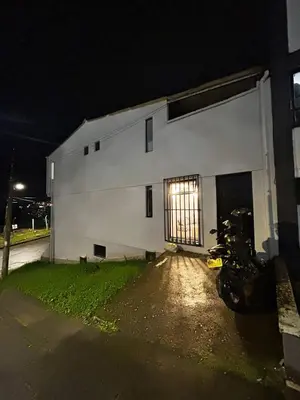 a white building with a motorcycle parked in front of it at Lujoso, relajante y Cómodo Apartaestudio en La Rambla in Manizales