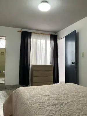 a bedroom with a large bed and a window at Apartamento cómodo en Medellín in Medellín
