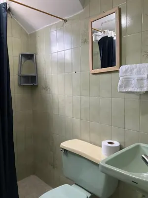 a bathroom with a toilet and a sink and a mirror at Apartamento cómodo en Medellín in Medellín