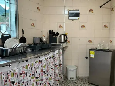 a kitchen with a counter with a sink and a refrigerator at Apartamento cómodo en Medellín in Medellín