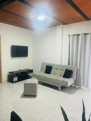 a living room with a couch and a flat screen tv at Hermosa Casa de descanso Villa María in Don Matías