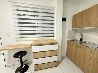 a kitchen with a window and a stool in a kitchen at Apartaestudio 105- Casa Bendita in Medellín