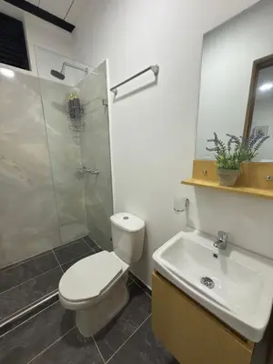 a bathroom with a toilet and a shower and a sink at Apartaestudio 105- Casa Bendita in Medellín