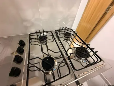 a stove top oven with four burners on it at Apartaestudio 105- Casa Bendita in Medellín
