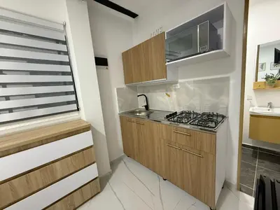 a small kitchen with a sink and a stove at Apartaestudio 105- Casa Bendita in Medellín