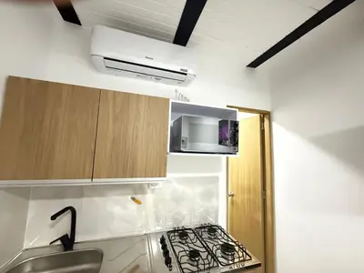a small kitchen with a stove and a sink at Apartaestudio 105- Casa Bendita in Medellín