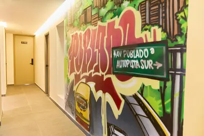 a wall in a hallway with a painting on it at Cozy Comforts at Rosa Negra Stadio in Medellín